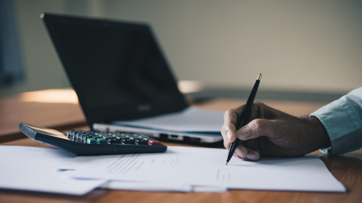 Businessman signing contract document on office desk