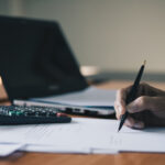 Businessman signing contract document on office desk