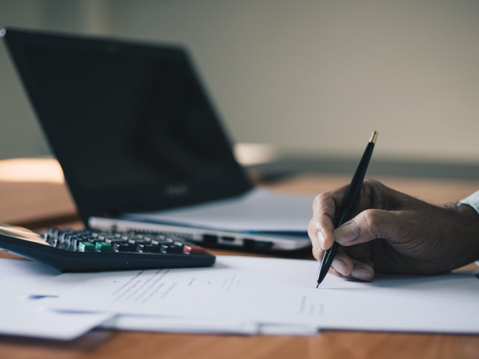 Businessman signing contract document on office desk