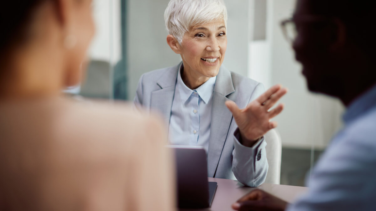 Financial advisor communicating with couple during the meeting in the office.