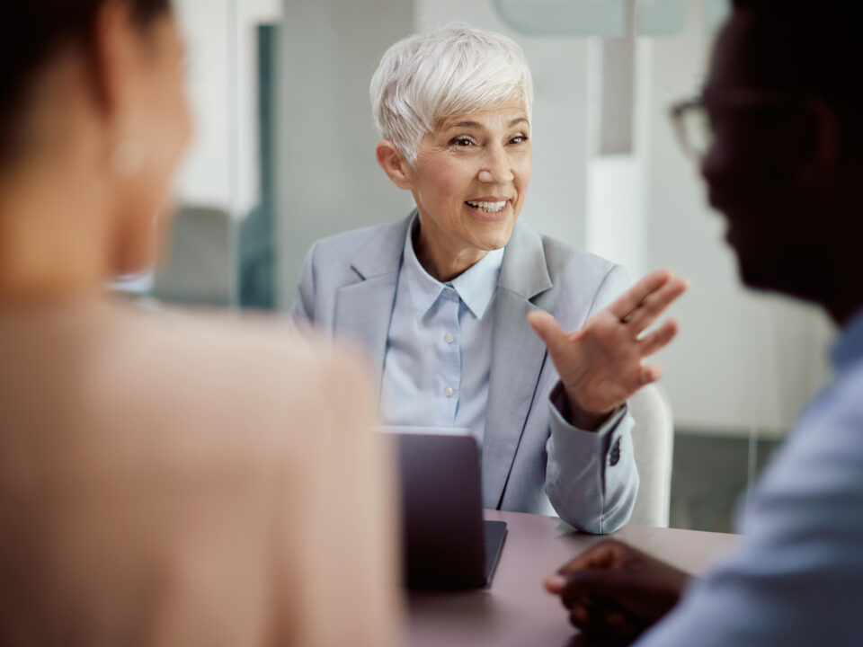 Financial advisor communicating with couple during the meeting in the office.